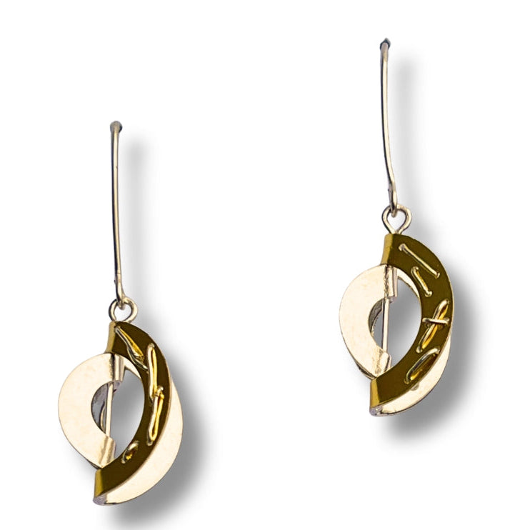 Pair of gold hanging earrings on a white background