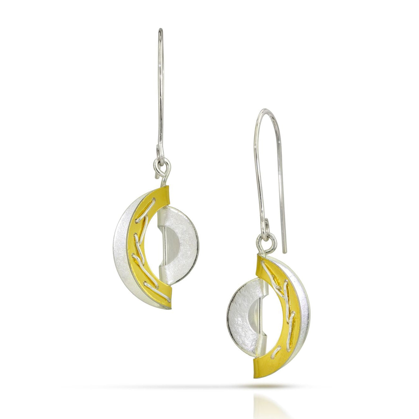 A pair of silver and yellow gold crescent moon drop earrings with textured silver circular elements and polished gold inner accents, shown on a white background.