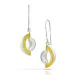 A pair of silver and yellow gold crescent moon drop earrings with textured silver circular elements and polished gold inner accents, shown on a white background.