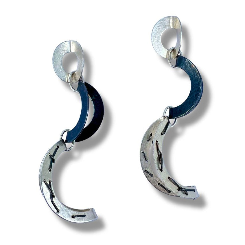 Pair of silver  earrings on a white background