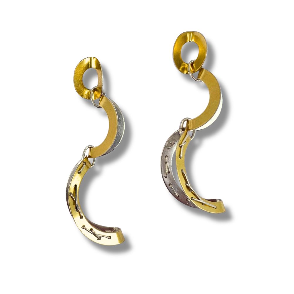 Gold and silver earring on a white background