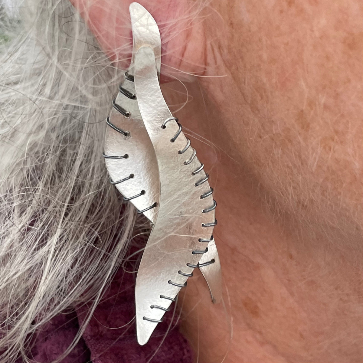 Suzanne Schwartz Wearing Wing Earrings