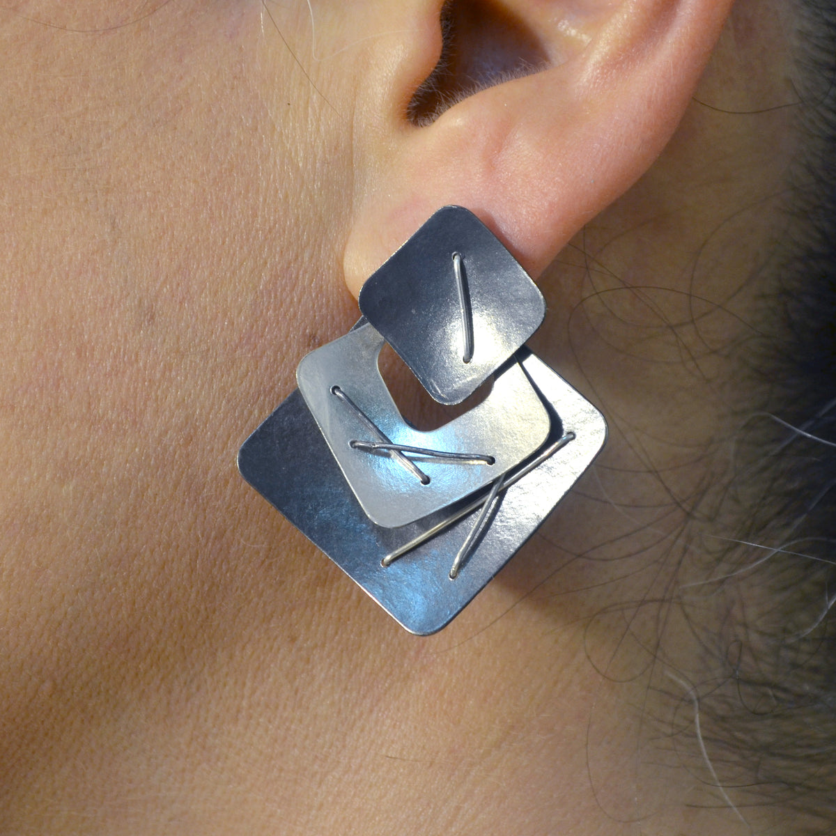 Suzanne Schwartz Wearing Three Piece Layered Earrings with Large Top