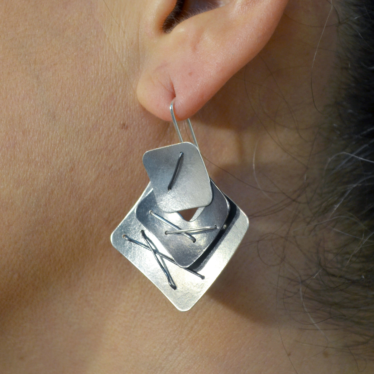 Suzanne Schwartz Wearing Three Piece Layered Earrings with Large Top